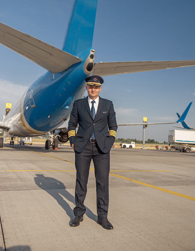 Veteran Air Warriors sponsor a vet participant standing in front of an airplane.